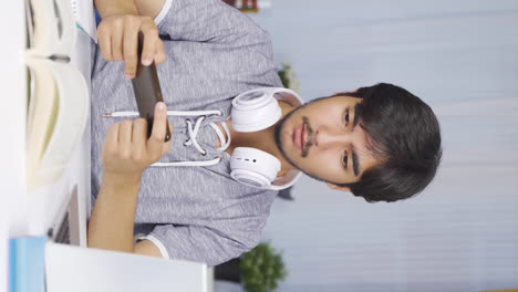 Vertical-video-of-Phone-Addicted-male-student.